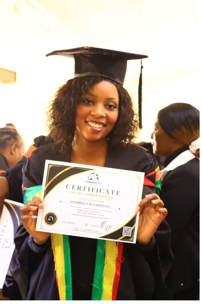 Graduate holding her certificate of completion