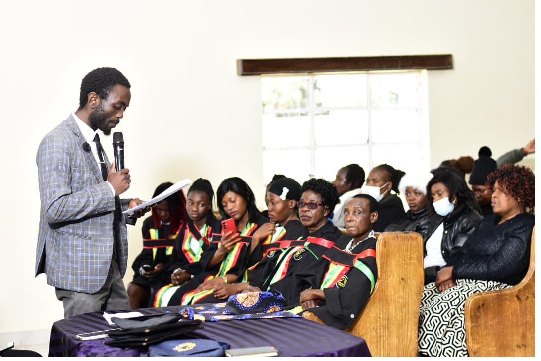 Speaker reading to graduates